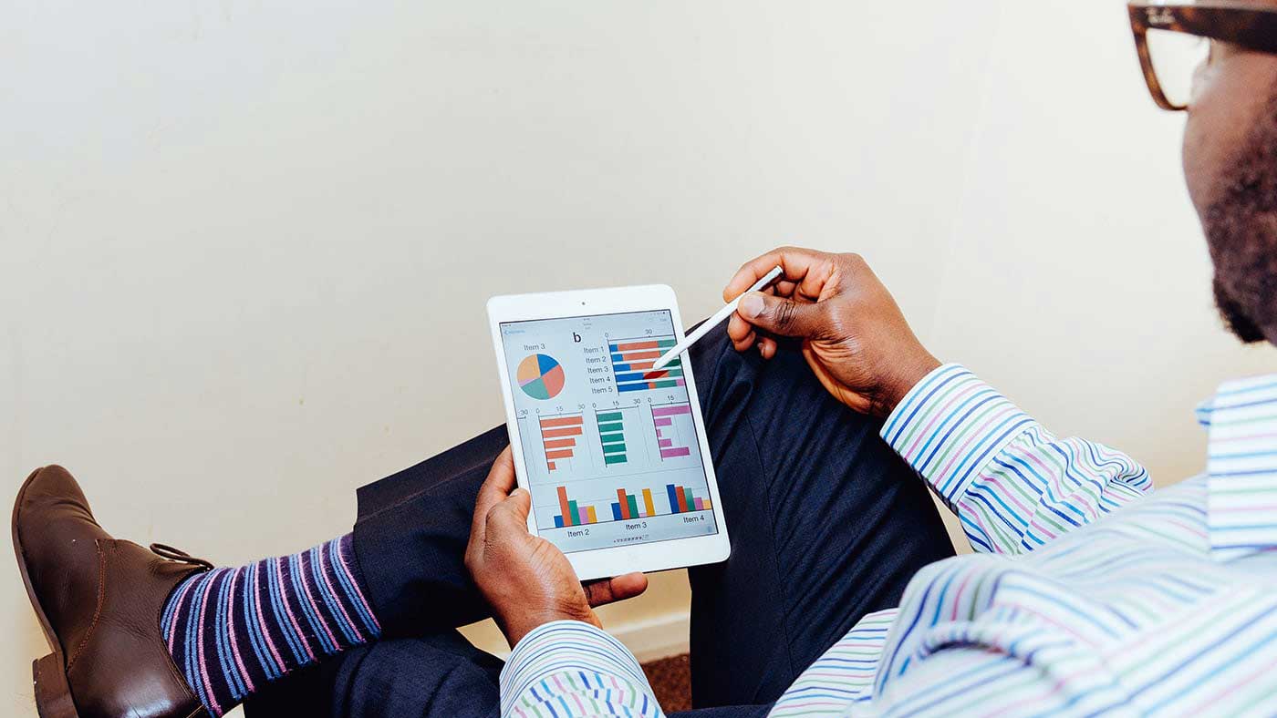 Man looking at tablet reports